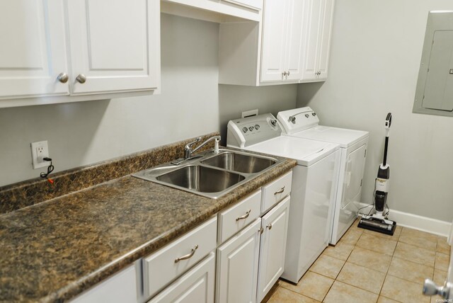 laundry room with light tile patterned flooring, separate washer and dryer, a sink, cabinet space, and electric panel