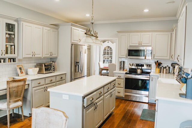 kitchen featuring appliances with stainless steel finishes, a center island, light countertops, and glass insert cabinets