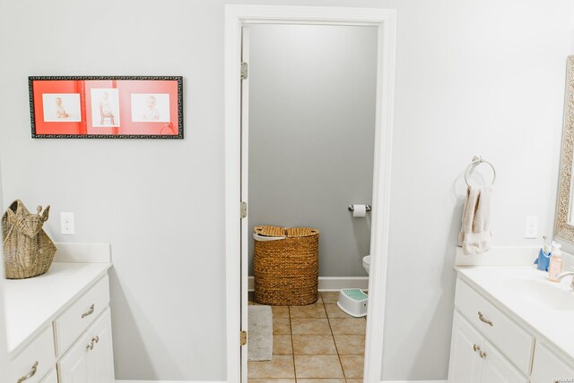 bathroom featuring vanity, baseboards, and tile patterned floors