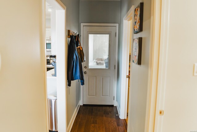 entryway featuring dark wood finished floors and baseboards