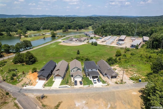 birds eye view of property with a water view, a forest view, and a residential view