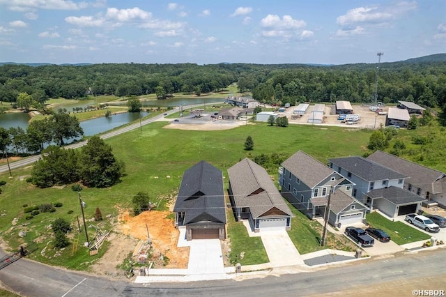 aerial view with a residential view, a water view, and a view of trees