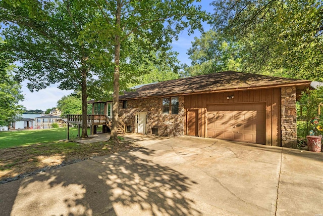 110 Spurwink Ln, Hot Springs, AR 71913 - view of side of property with stone siding, driveway, a wooden deck, an attached garage, and stairway