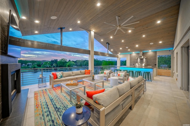 view of patio / terrace featuring a ceiling fan, outdoor dry bar, and an outdoor living space