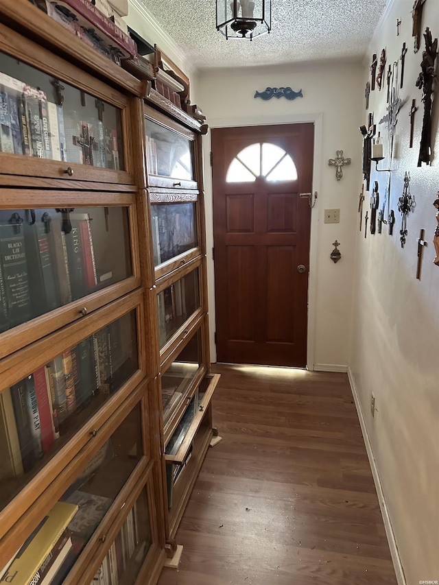 entryway featuring dark wood finished floors, a textured ceiling, and baseboards