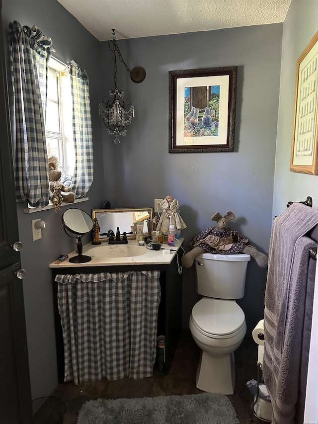 half bathroom with vanity and toilet