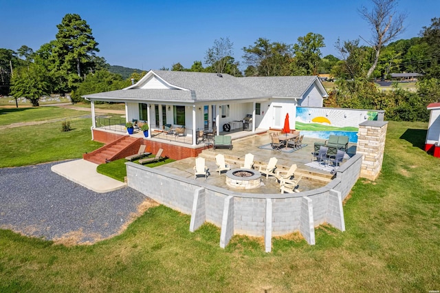 exterior space with a patio, an outdoor fire pit, stairway, and a shingled roof