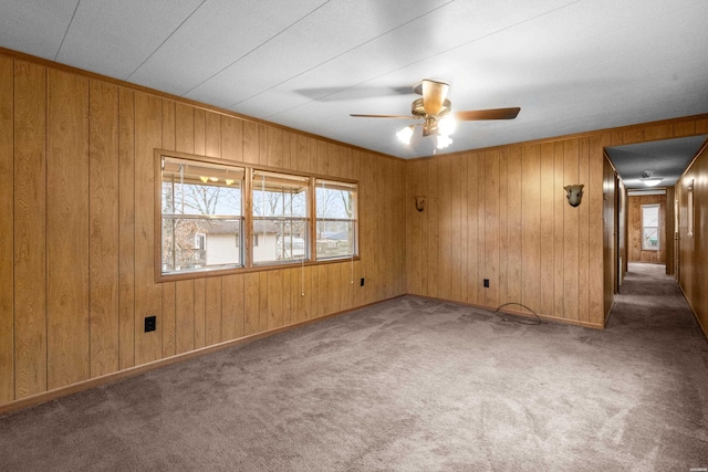 unfurnished room with dark carpet, a ceiling fan, and baseboards