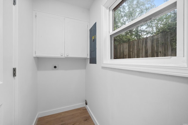 101 Southern Hills Dr, Hot Springs, AR 71913 - laundry area featuring cabinet space, plenty of natural light, electric dryer hookup, and wood finished floors
