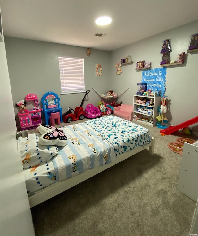 carpeted bedroom featuring visible vents