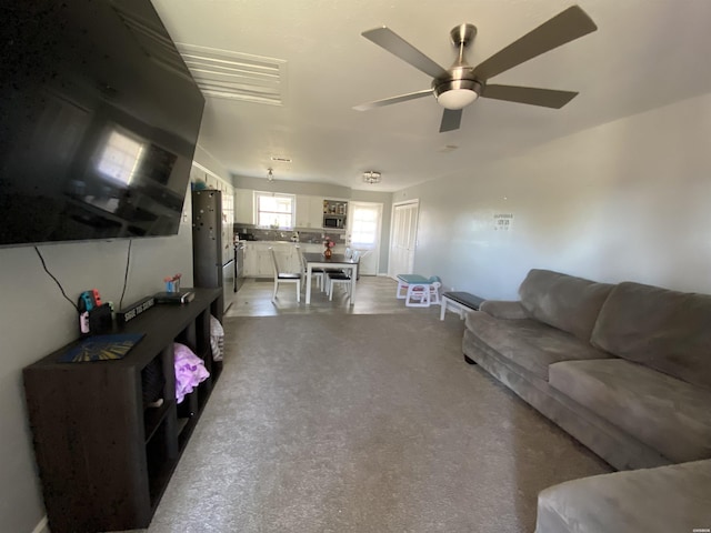 living area with a ceiling fan