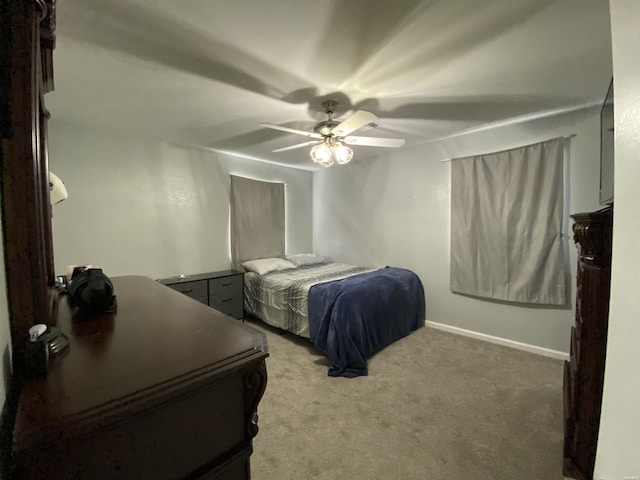 carpeted bedroom with a ceiling fan and baseboards