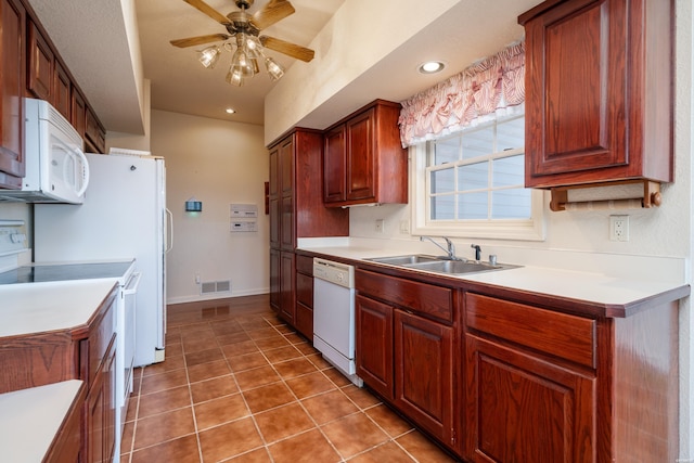 kitchen featuring white appliances, visible vents, light countertops, and a sink