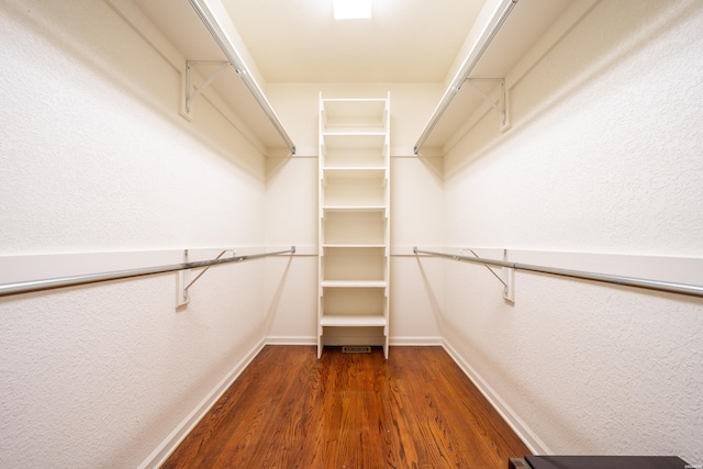 walk in closet featuring dark wood-type flooring