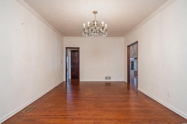 unfurnished room with ornamental molding, visible vents, and dark wood finished floors