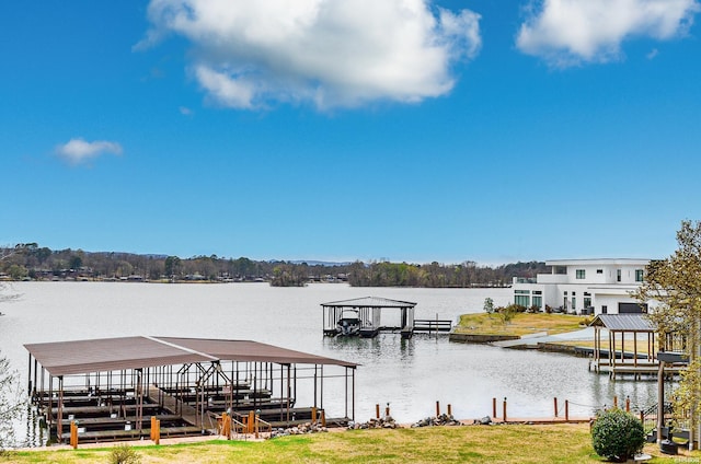 dock area with a lawn, a water view, and boat lift