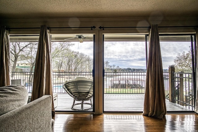 208 Daffodil St Unit D-1, Hot Springs, AR 71913 - doorway to outside with a healthy amount of sunlight, dark wood-style floors, and a textured ceiling
