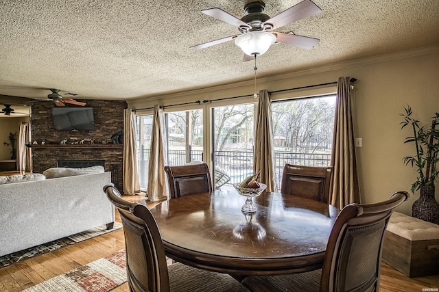 208 Daffodil St Unit D-1, Hot Springs, AR 71913 - dining room featuring ornamental molding, a wealth of natural light, a large fireplace, and wood finished floors