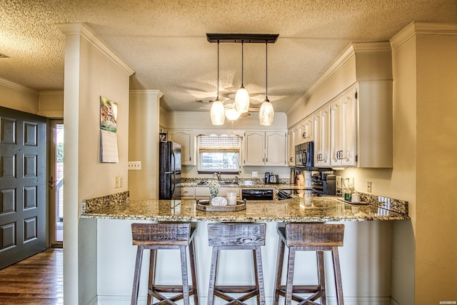 208 Daffodil St Unit D-1, Hot Springs, AR 71913 - kitchen featuring a peninsula, black appliances, hanging light fixtures, and light stone countertops
