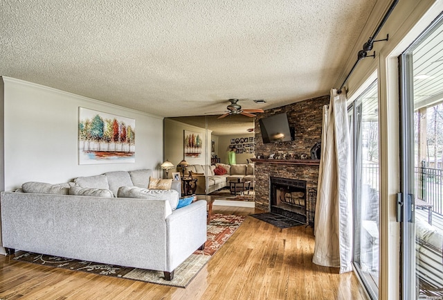 208 Daffodil St Unit D-1, Hot Springs, AR 71913 - living room featuring a textured ceiling, ornamental molding, a brick fireplace, and wood finished floors