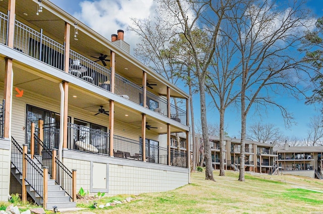 208 Daffodil St Unit D-1, Hot Springs, AR 71913 - exterior space with a chimney, a lawn, stairway, a ceiling fan, and a balcony