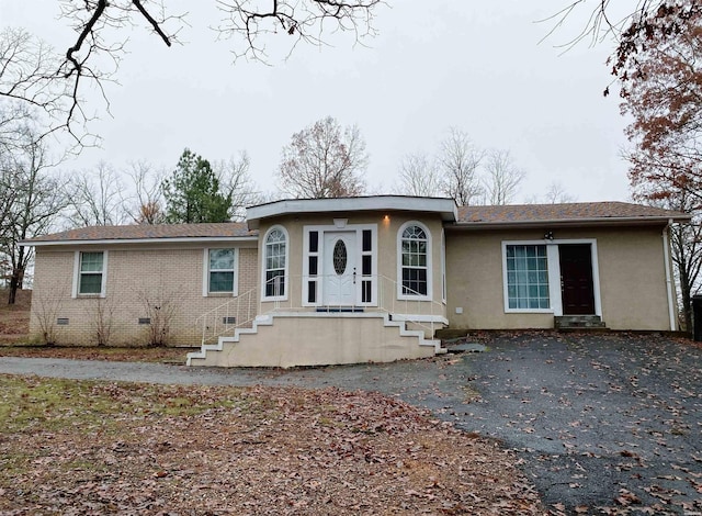 view of front of home with brick siding and crawl space