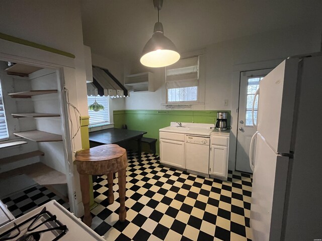 kitchen featuring open shelves, light countertops, hanging light fixtures, white cabinets, and white appliances