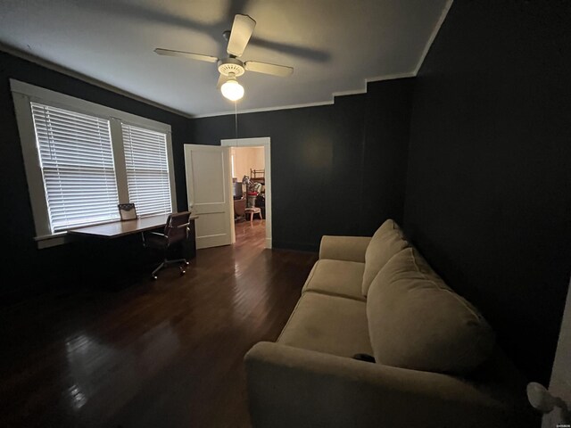 home office with ornamental molding, dark wood-style flooring, ceiling fan, and baseboards