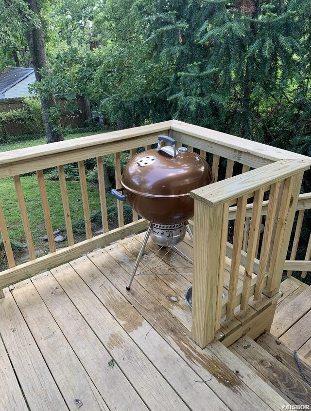 wooden terrace featuring fence