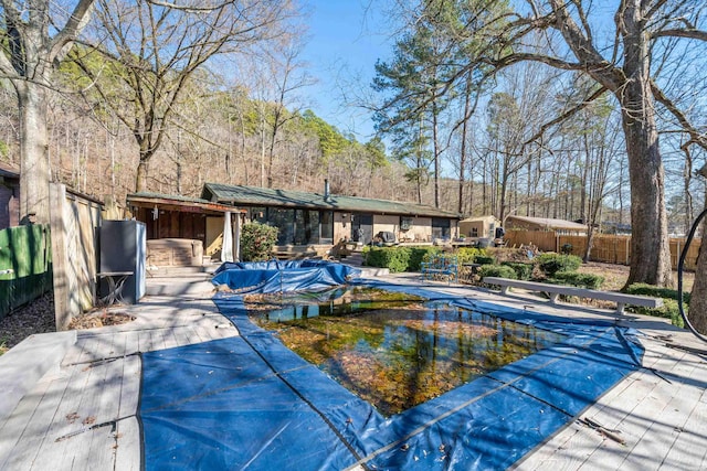 view of swimming pool with fence, a fenced in pool, and a patio