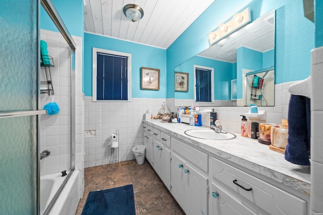 full bath with bath / shower combo with glass door, wainscoting, wood ceiling, vanity, and tile walls