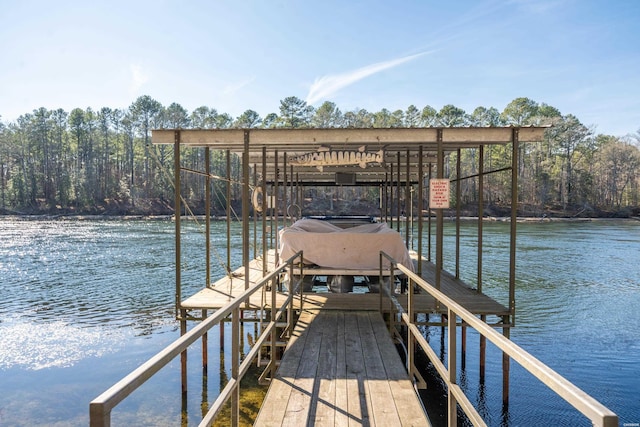 dock area with a water view and boat lift