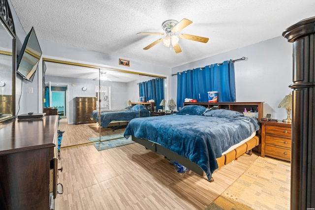 bedroom with a textured ceiling and a ceiling fan