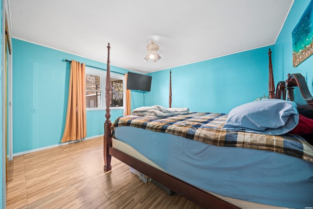 bedroom with baseboards and wood finished floors