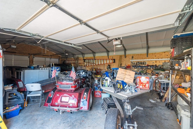 garage with a garage door opener and a workshop area