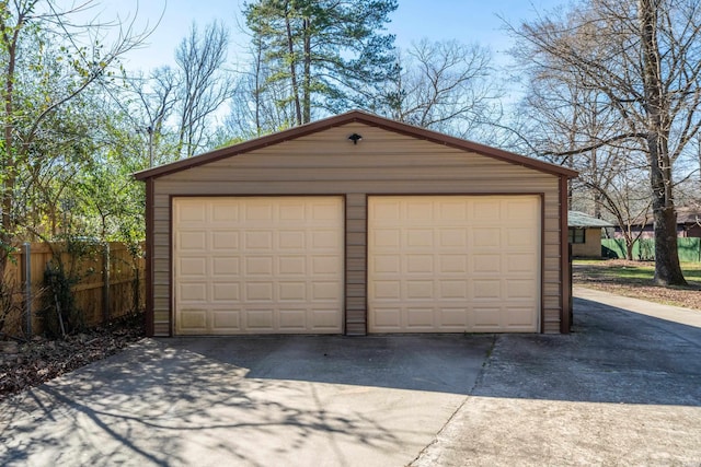 detached garage featuring fence