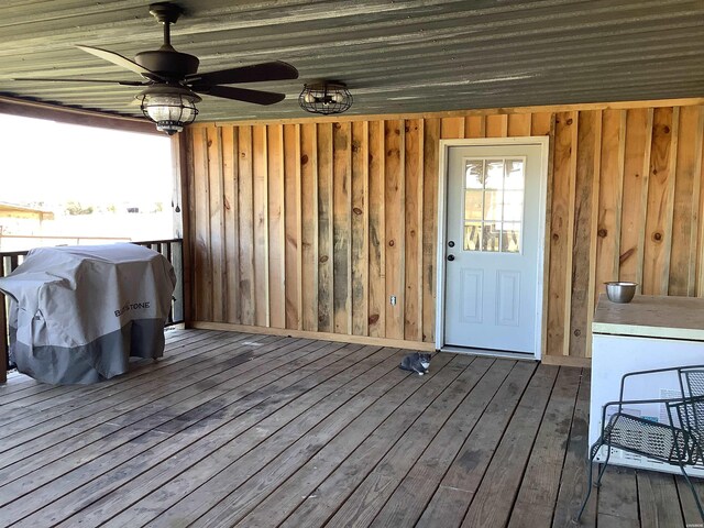 wooden deck with a grill and a ceiling fan