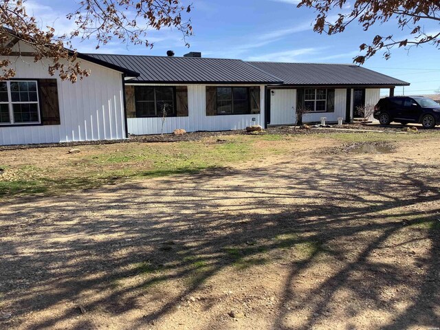 single story home with metal roof and a carport