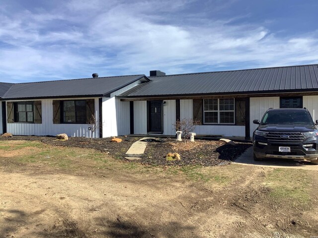 single story home with metal roof