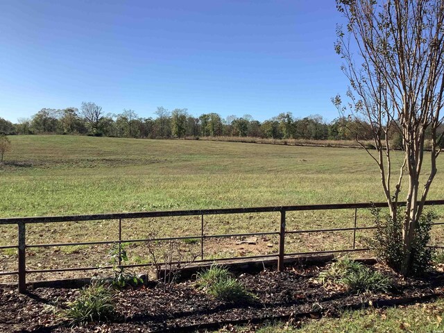 view of yard featuring a rural view and fence