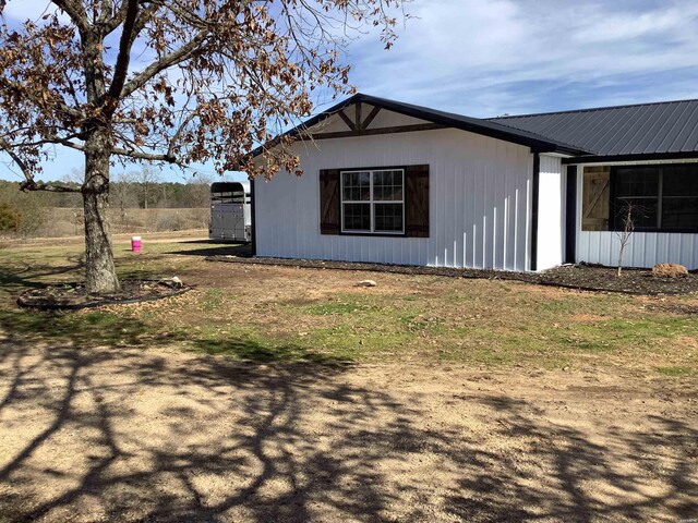 view of side of home featuring metal roof