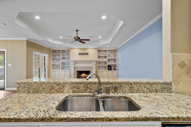 121 Gardens Gate Dr, Hot Springs, AR 71913 - kitchen with a ceiling fan, light stone countertops, a tray ceiling, a sink, and open floor plan