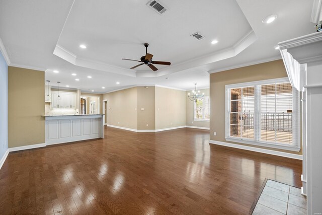 121 Gardens Gate Dr, Hot Springs, AR 71913 - unfurnished living room featuring a tray ceiling, visible vents, ceiling fan with notable chandelier, and ornamental molding