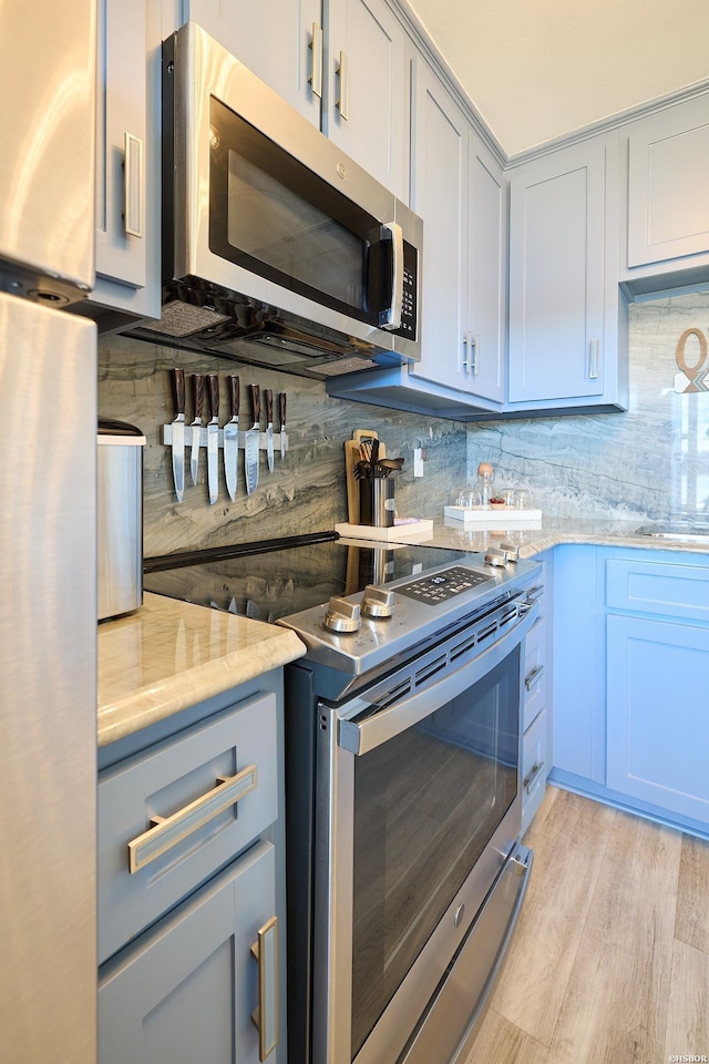 210 Aberina St Unit C-5, Hot Springs, AR 71913 - kitchen featuring appliances with stainless steel finishes, tasteful backsplash, light wood-type flooring, and light stone counters
