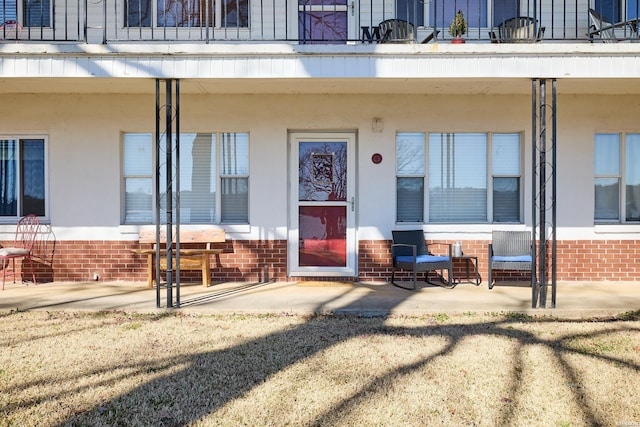 210 Aberina St Unit C-5, Hot Springs, AR 71913 - doorway to property featuring brick siding, covered porch, and a balcony