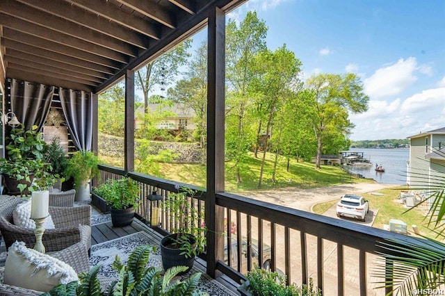 sunroom / solarium featuring a water view and a wealth of natural light