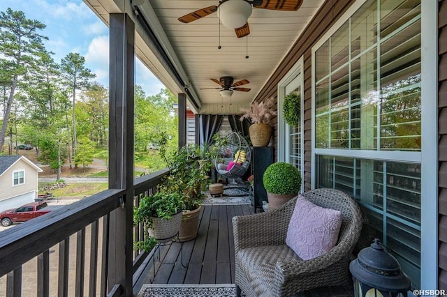 wooden deck with a ceiling fan