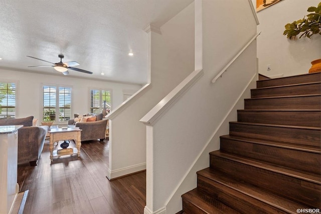 staircase with baseboards, a ceiling fan, and wood finished floors