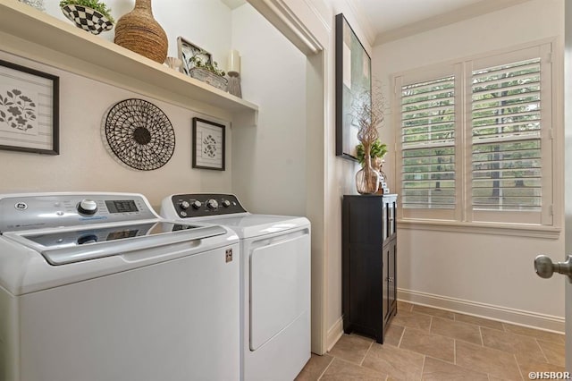 clothes washing area featuring crown molding, baseboards, laundry area, and independent washer and dryer