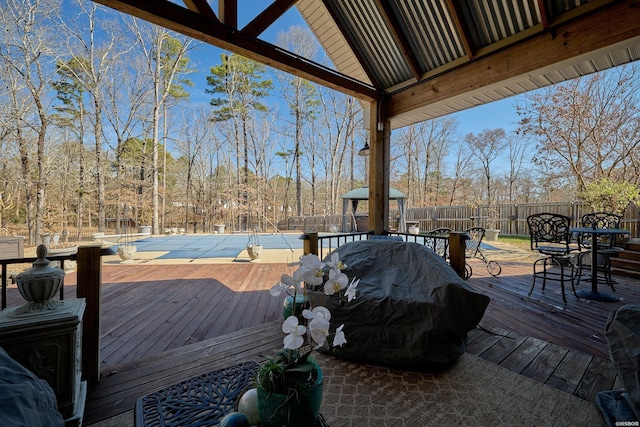 deck featuring outdoor dining area and fence